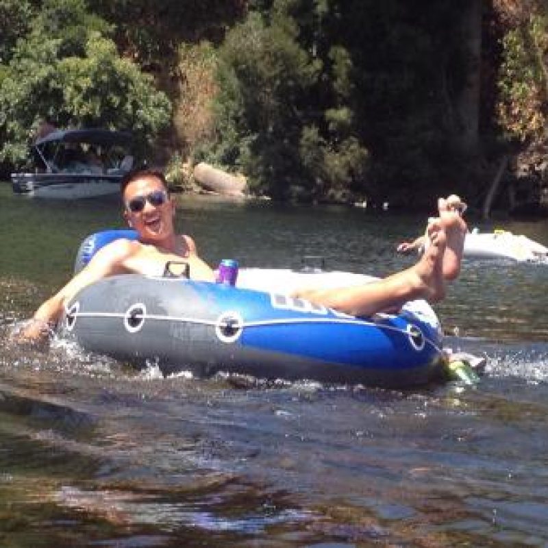 man tubing in the American River